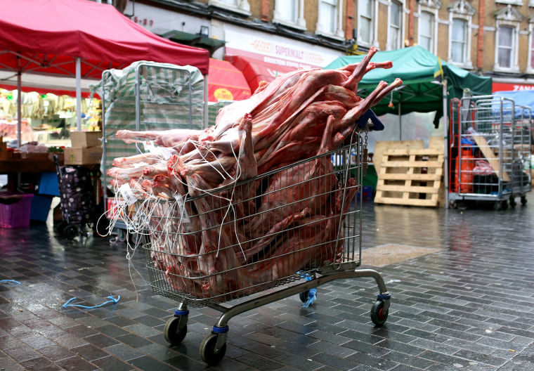 Image: Raw meat sits piled in a shopping cart on Electric Avenue in Brixton