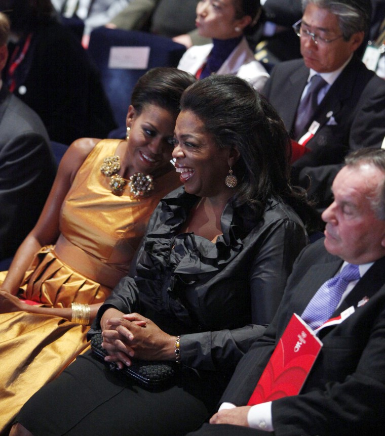 Former First lady Michelle Obama sits with Oprah Winfrey and Chicago Mayor Richard Daley at the opening ceremonies of the the International Olympic Committee (IOC) Session in 2009.