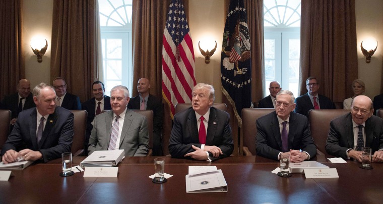Image:  President Donald Trump, center, speaks during a cabinet meeting at the White House