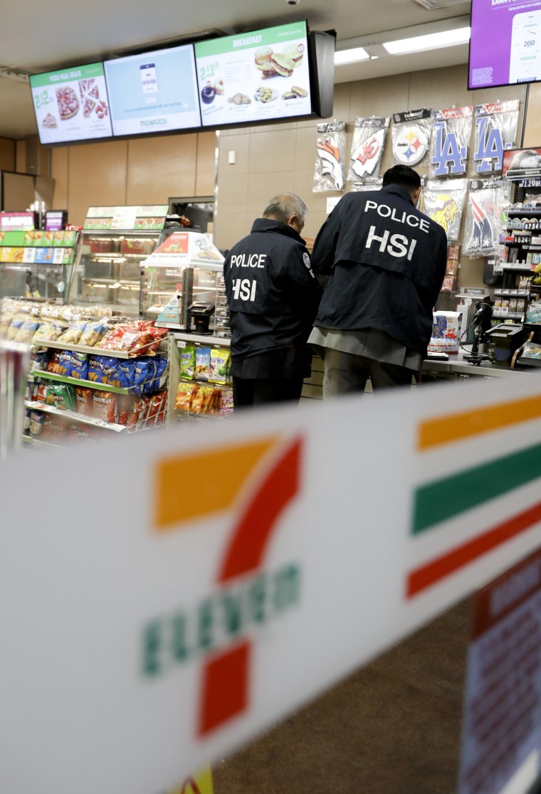 Image: U.S. Immigration and Customs Enforcement agents serve an employment audit notice at a 7-Eleven