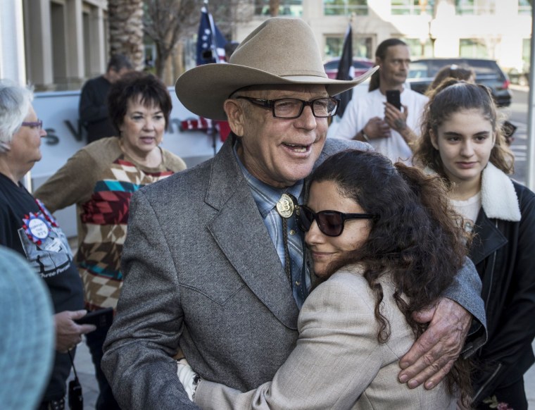 Image: Cliven Bundy hugs Maysoun Fletcher, an attorney for his son Ryan