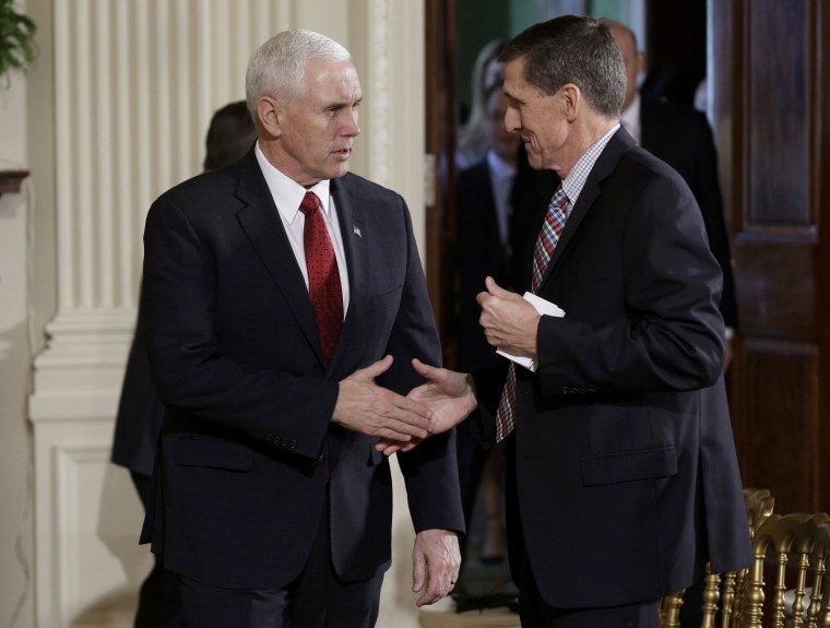 Image: U.S. Vice President Pence greets National Security Advisor Flynn before Abe-Trump news conference at the White House in Washington.