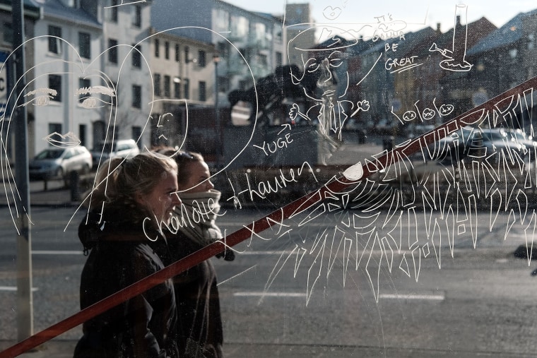 Image:  Women walk down a shopping street