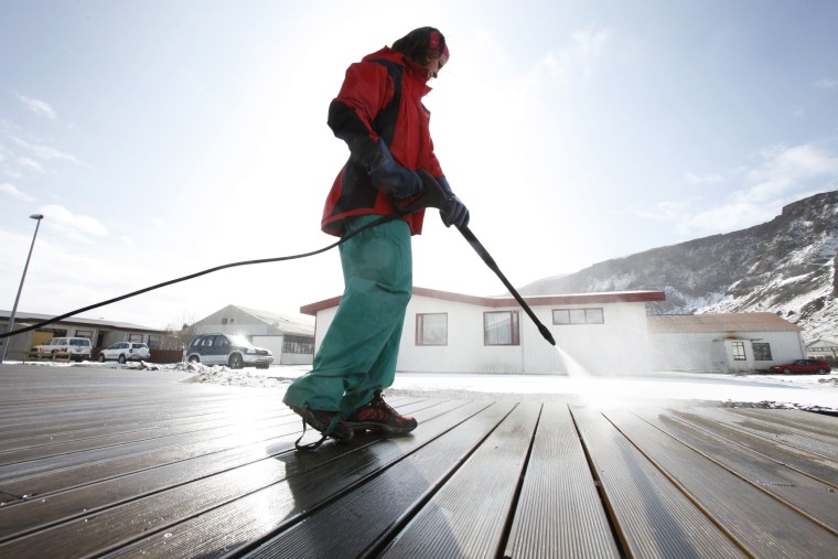 Image: A woman uses a pressure washer