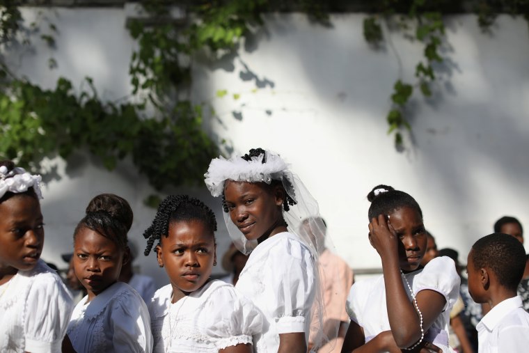 Image: Young girls take part in a Corpus Christi procession in Port-au-Prince