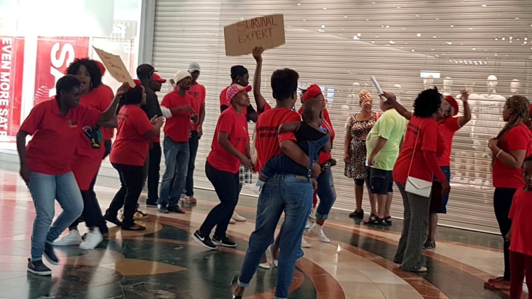 Image: People protest in front of H&amp;M store in Cape Town