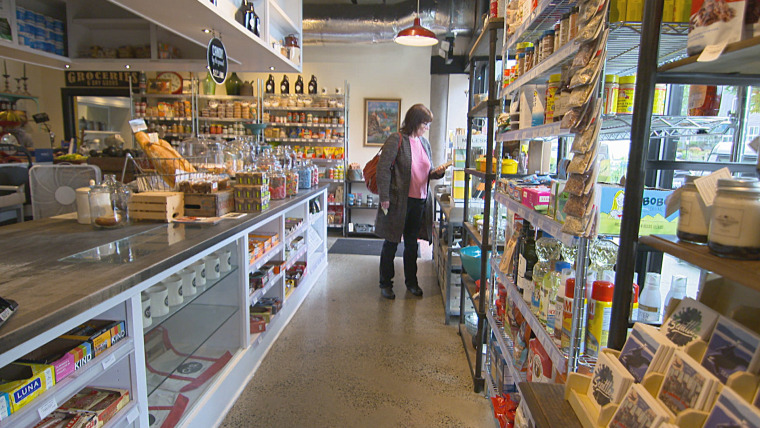 Woman shops at Cone and Steiner in Seattle, Wa. that specializes in local goods and is a business creating jobs.