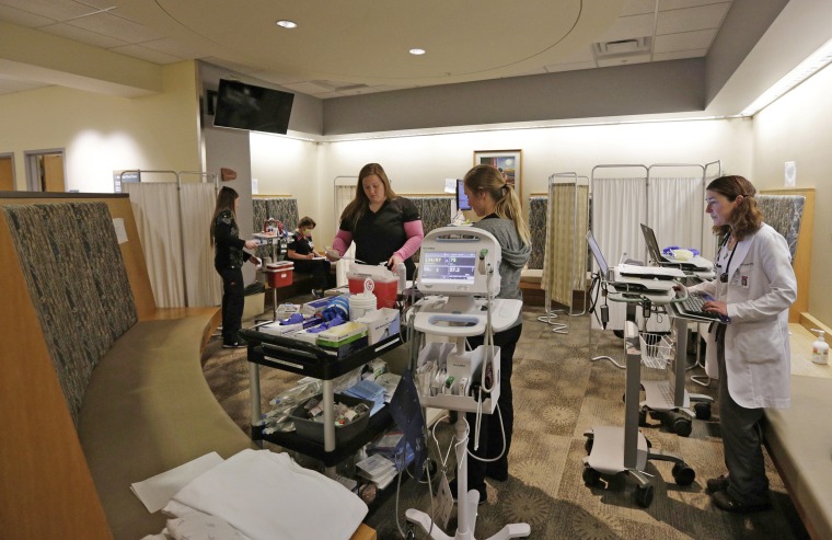 St. Charles Bend emergency department staff tend to patients in a converted waiting area at the hospital in Bend, Oregon, on Jan. 9. The waiting area has been used to treat and triage patients to handle the increasing number of patients, most of them suffering from the flu.