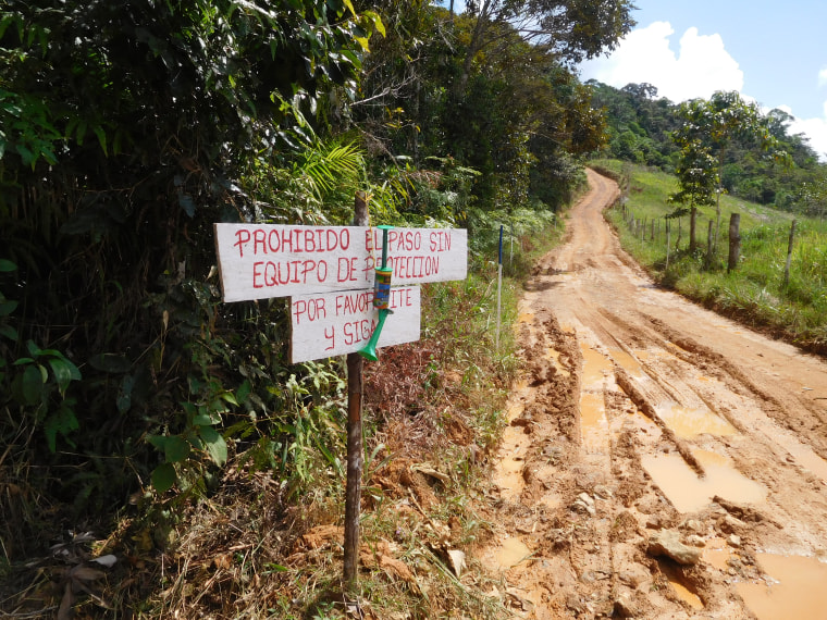 Sign at Halo Trust reads "Passing without protective equipment is prohibited in this area."