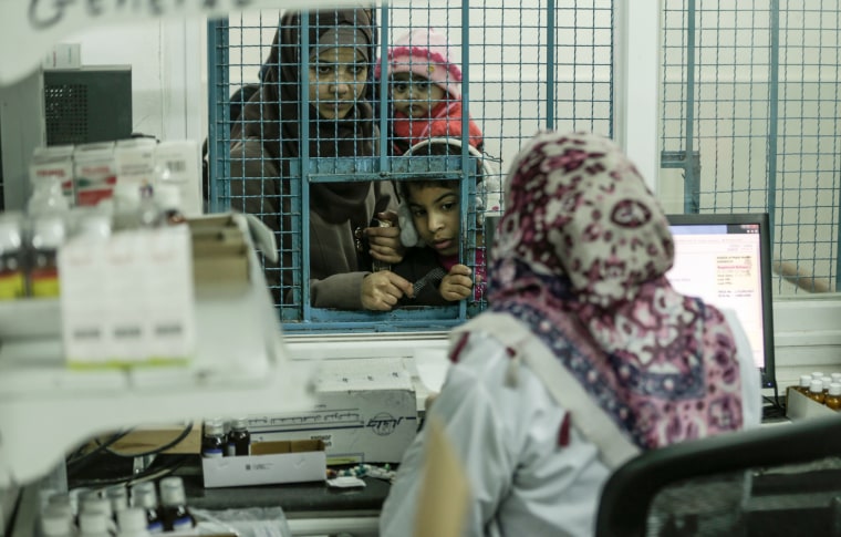 Image: Palestinian patients receive medication at an UNRWA-run clinic in al-Nusirat camp on Jan. 17.