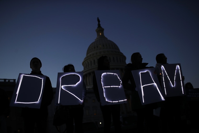 Image: Protesters advocating for the DREAM Act hold a candlelight vigil