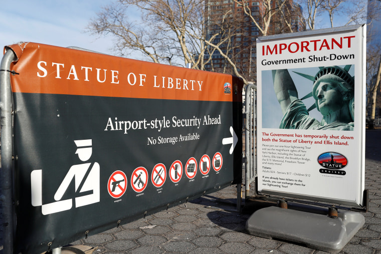 Image: A sign announcing the closure of the Statue of Liberty, due to the U.S. government shutdown, sits near the ferry dock to the Statue of Liberty at Battery Park in Manhattan, New York