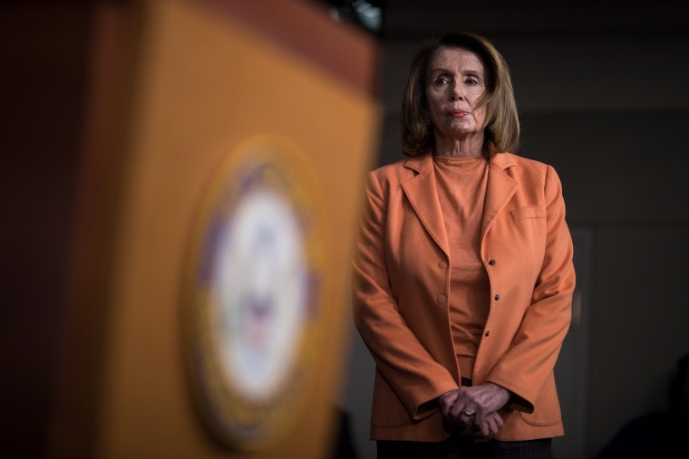 Image: House Minority Leader Nancy Pelosi, D-Calif., looks on during a press conference