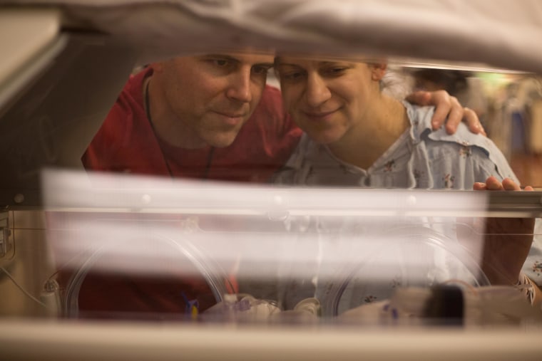 Chad and Amy Kempel peek at one of their five new additions.