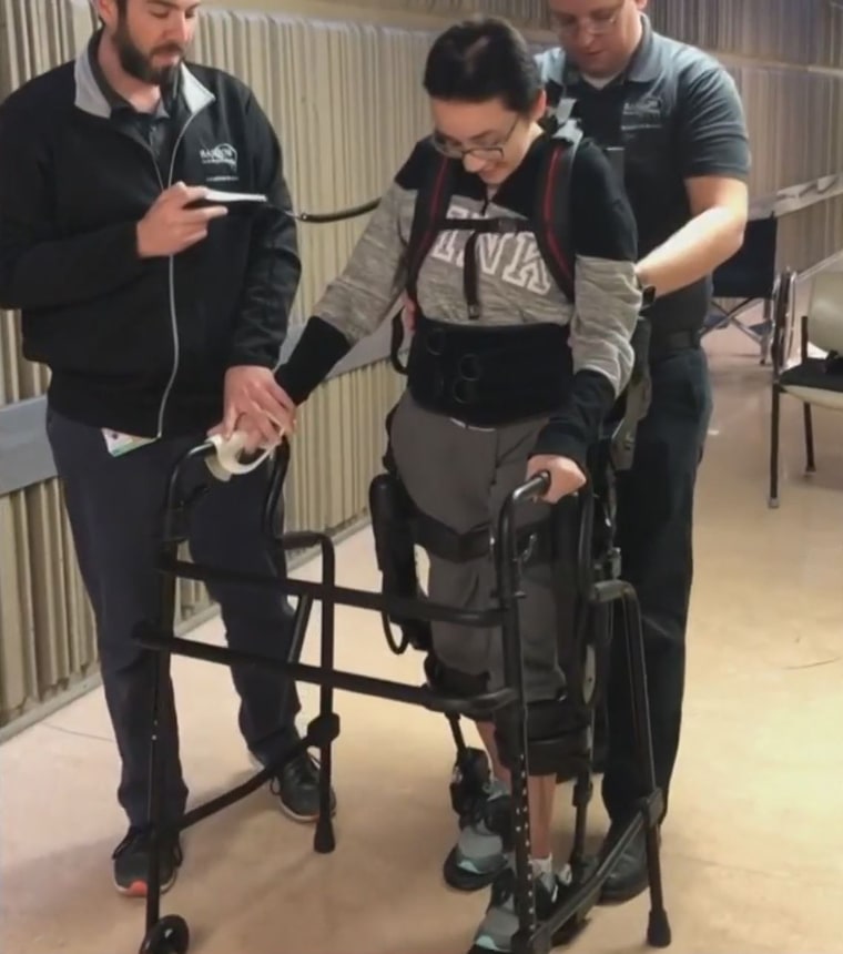 A robotic exoskeleton has helped her as she learns to walk again. 