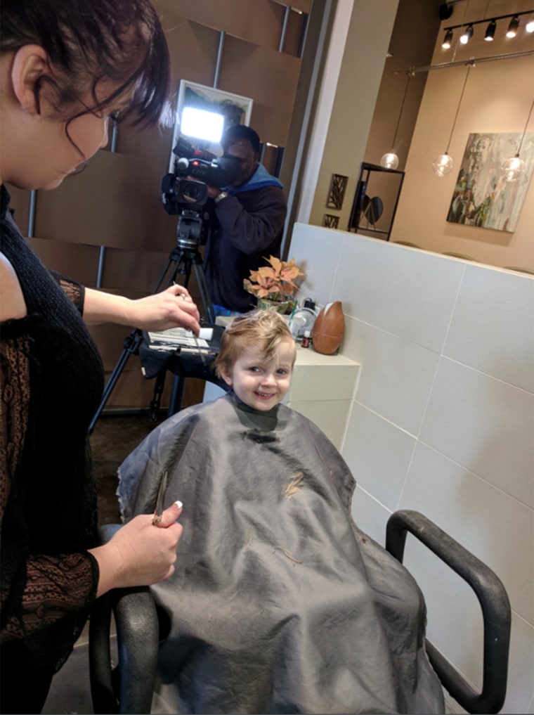 Teig Harris, now cancer free, gets her first haircut at the age of four after years of chemo therapy.