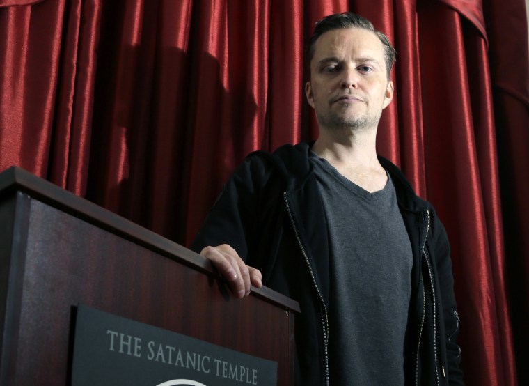 Image: Lucien Greaves stands inside the international headquarters of the Satanic Temple