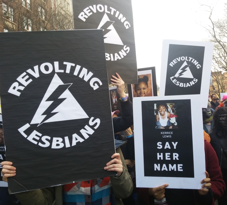 Members of the group Revolting Lesbians hold up signs at the Women's March in New York City on Jan. 20, 2018.