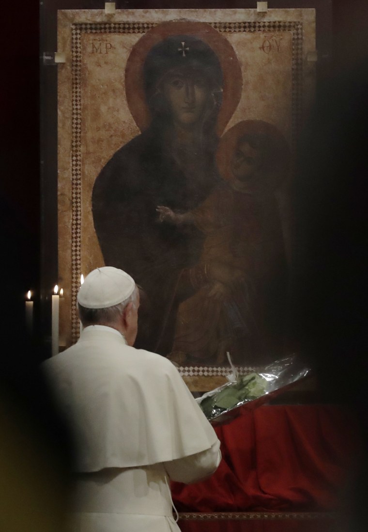 Image: Pope Francis prays in front of a portrait of the Virgin Mary