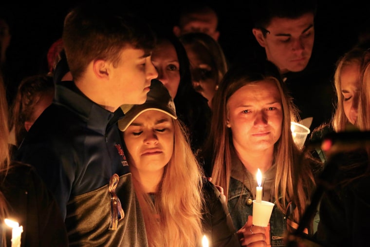 Image: People attend a vigil