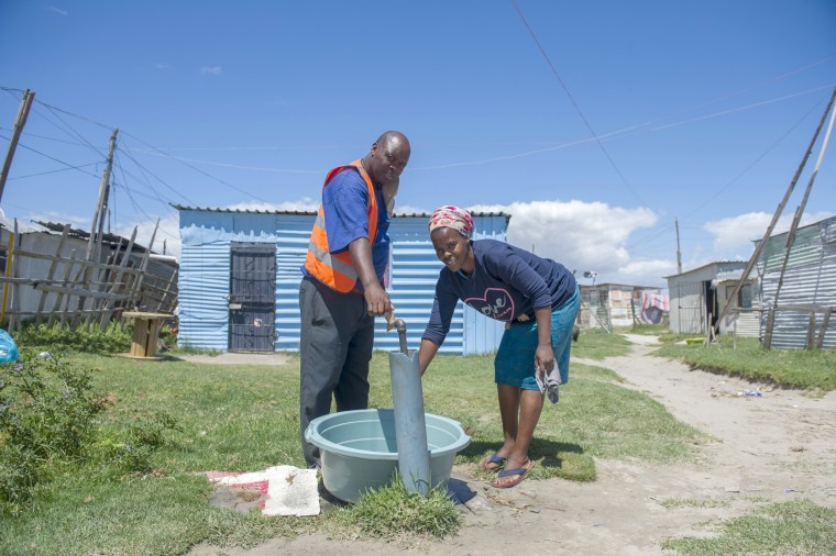 Image: People collect water from a communal tap at an informal settlement near Cape Town, South Africa, Tuesday, Jan. 23, 2018, as a harsh drought may force South Africa's showcase city of Cape Town to turn off most of its taps.