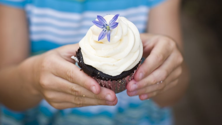 girl poses with cupcake