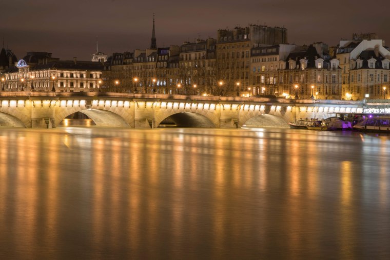Image: The Seine passes through the Pont Neuf bridge in Paris