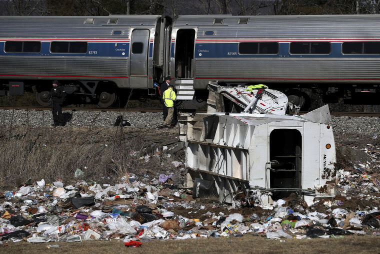 Image: Emergency personnel work at the scene of a train crash