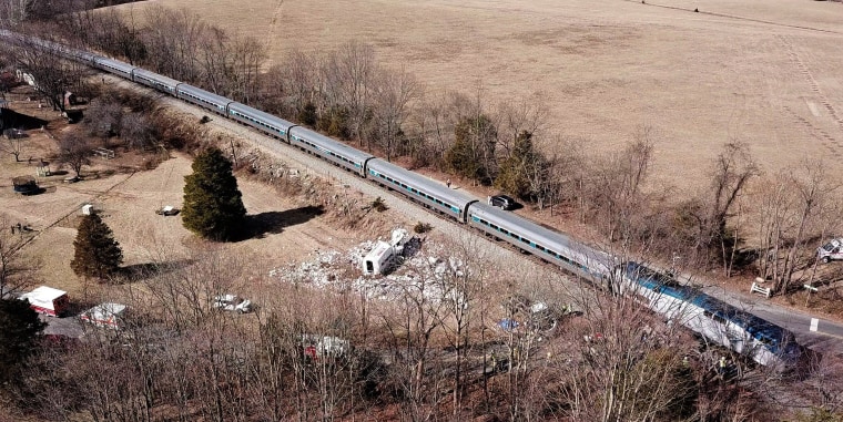 Image: The wreckage of a garbage truck lies beside an Amtrak passenger train after a collision in Crozet