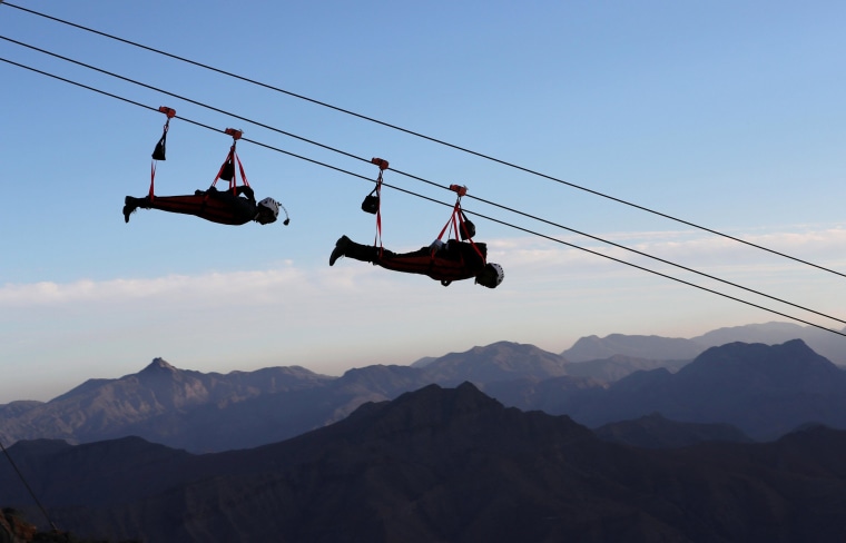 Image: People ride world's longest zip-line over Ras al-Khamiah's Jabal Jais Mountain