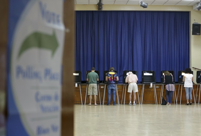 Image: People vote in the general election in Miami Shores