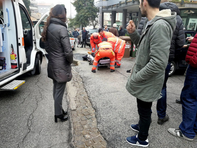 Image: Healthcare personnel take care of an injured person after being shot by gun fire from a vehicle, in Macerata, Italy, on Feb. 3, 2018.