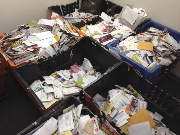 Image: Undated handout picture of mail that a New York City mailman allegedly stashed away in his home and car