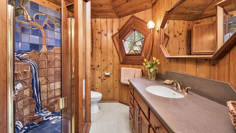 The bathroom features custom tiling.