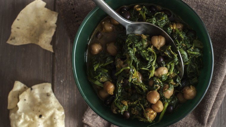 Bowl of vegetarian spinach lentil soup with chick-peas