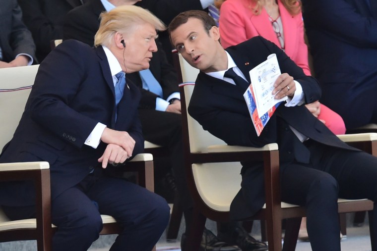 US President Donald Trump (L) and his French counterpart Emmanuel Macron chat as they watch the annual Bastille Day military parade on the Champs-Elysees avenue in Paris on July 14, 2017.

The parade on Paris's Champs-Elysees will commemorate the centenary of the US entering WWI and will feature horses, helicopters, planes and troops. / AFP PHOTO / CHRISTOPHE ARCHAMBAULTCHRISTOPHE ARCHAMBAULT/AFP/Getty Images