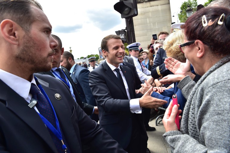 French President Emmanuel Macron meets the crowds following the annual Bastille Day military parade on the Champs-Elysees avenue in Paris on July 14, 2017.

The parade on Paris's Champs-Elysees will commemorate the centenary of the US entering WWI and will feature horses, helicopters, planes and troops. / AFP PHOTO / POOL / CHRISTOPHE ARCHAMBAULTCHRISTOPHE ARCHAMBAULT/AFP/Getty Images