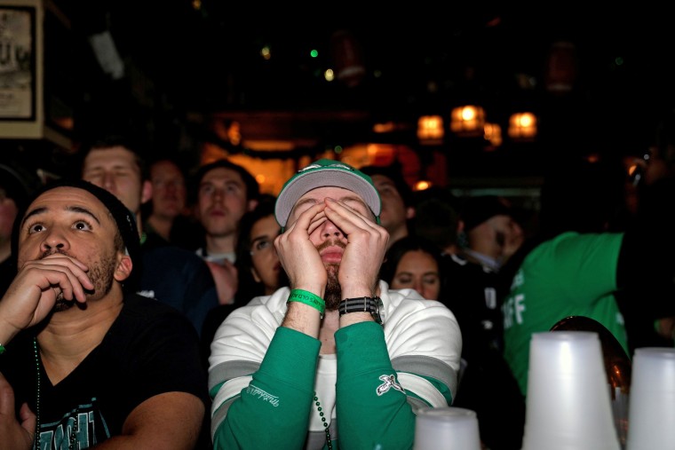 Image: Football fans react as they watch Super Bowl LII between the New England Patriots and the Philadelphia Eagles at McGillin's Olde Ale House in Philadelphia