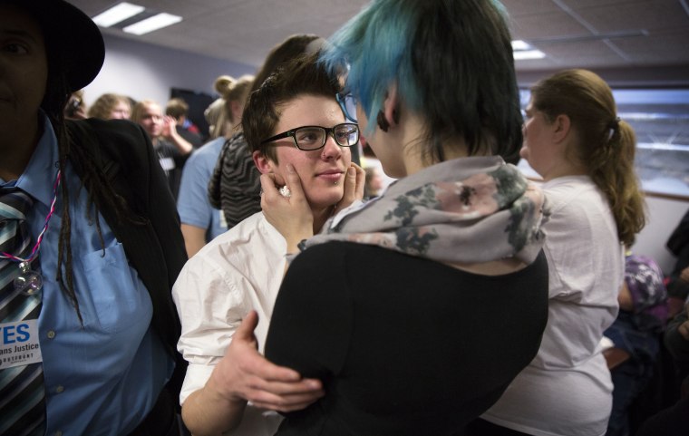 Image: A transgender high school student hugs his girlfriend