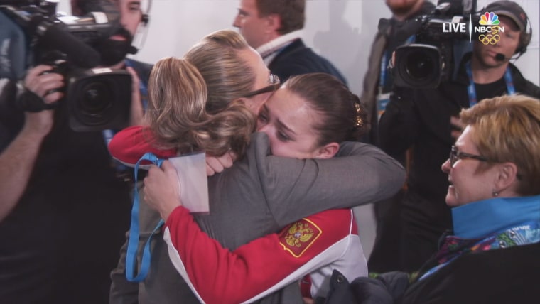 Image: Adelina Sotnikova is embraced by judge Alla Shekhovtsova after winning gold at the 2014 Sochi Winter Olympic Games