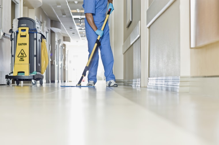 Image: A janitor mops a hospital floor