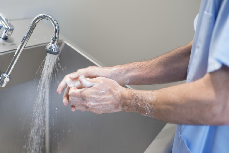 Image: A doctor washes his hands