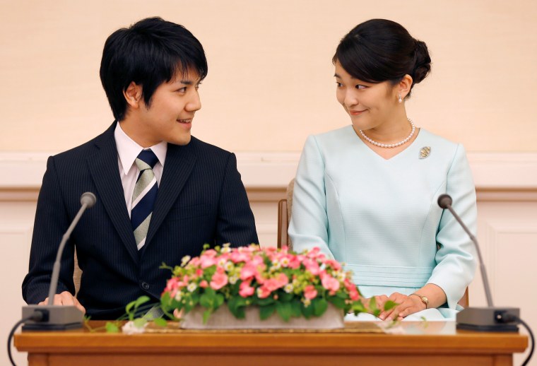 Image: Princess Mako and her fiancee Kei Komuro smile during a press conference to announce their engagement at Akasaka East Residence in Tokyo