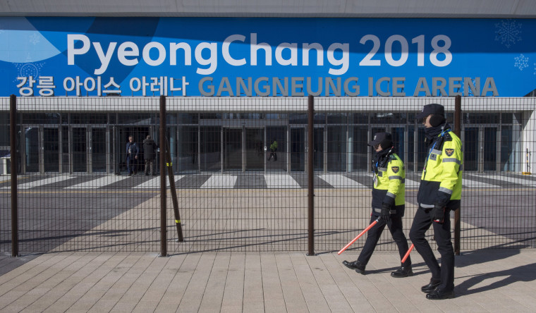 Image: Police officers walk the perimeter of the Gangneung Ice Arena
