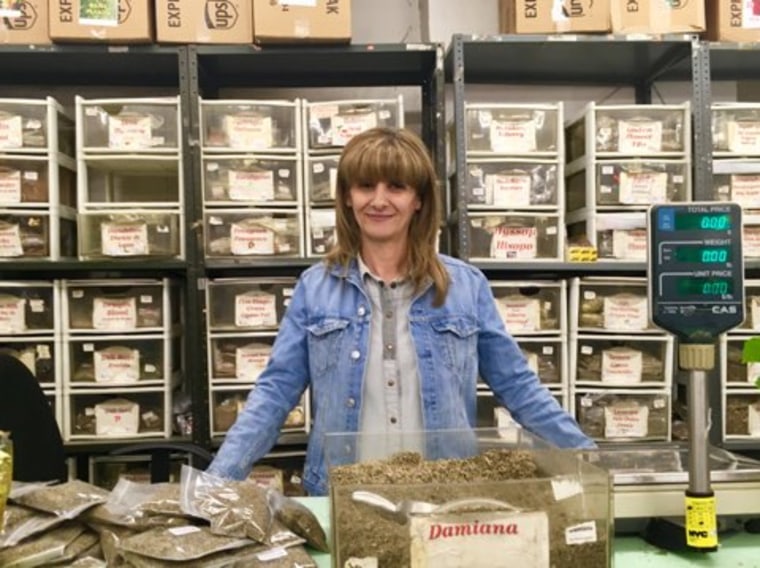 Long-time employee Rita Martinez, proudly stands behind her desk. She consults with dozens of clients daily and helps them figure out what types of herbs and plants are best depending on their ailment.