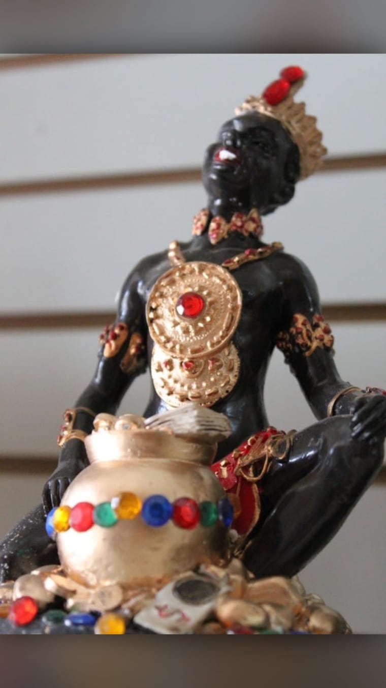 An Afro-Carribean orisha known as Shango sits perched upon a shelf inside San Elias Botanica Flowers. Shango is a feared god in the Yoruba religion. 