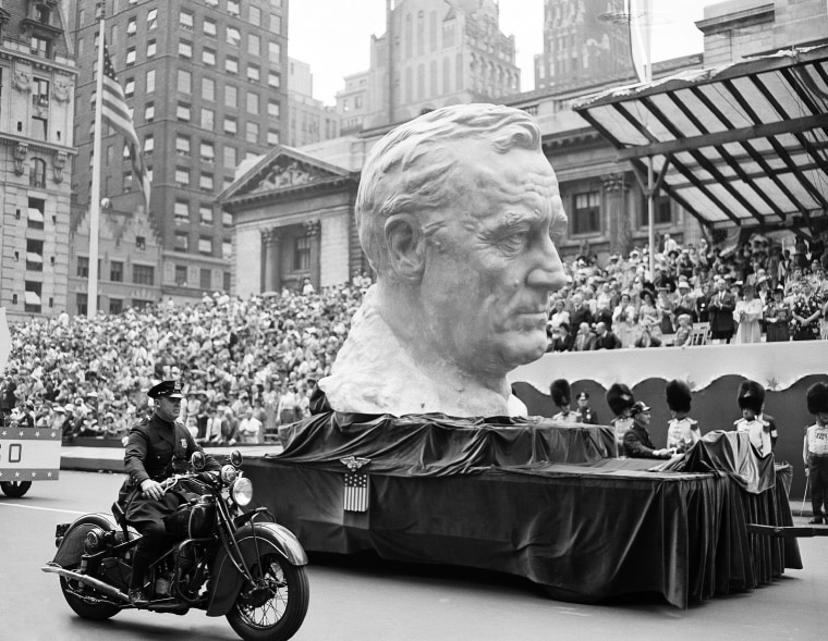 Image: A float carrying a bust of President Franklin Roosevelt rolls up Fifth Avenue during a war parade