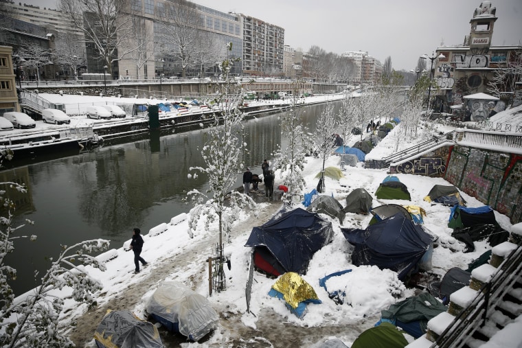 A makeshift migrant camp is blanketed in snow along Saint-Martin canal Feb. 7.