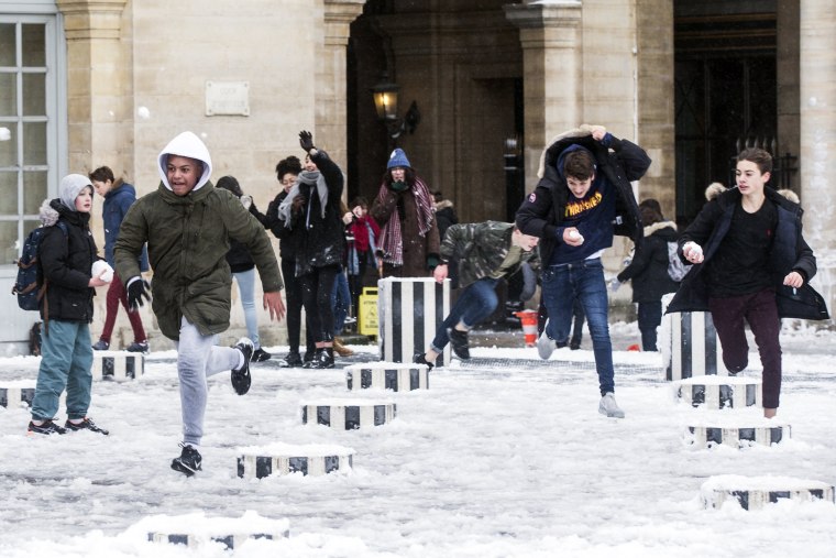 Students play in the snow in the Colonnes de Buren in Paris on Feb. 7.