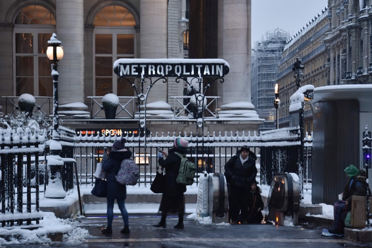 People stand outside an entrance to a metro station on Feb.7.